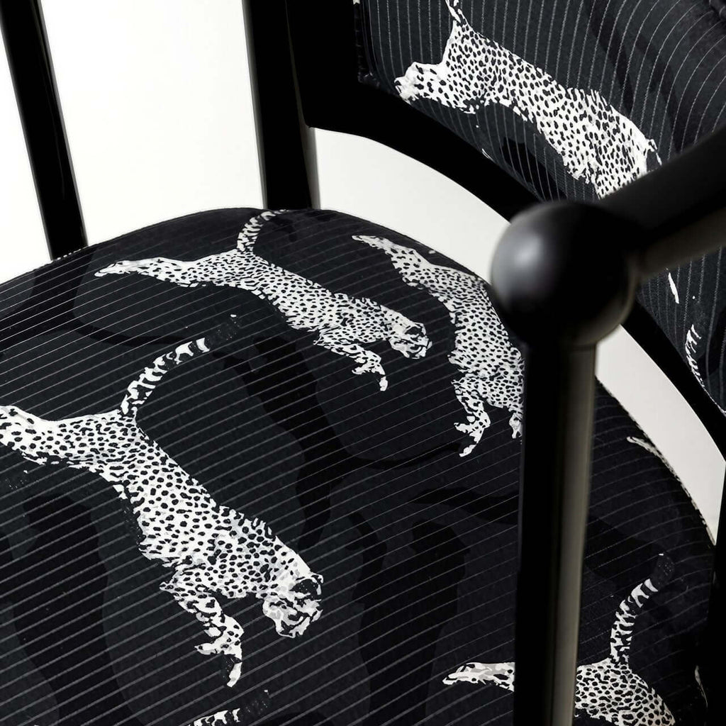 Single vintage dining chair with black fabric and leopard print upholstery