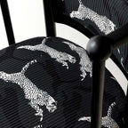 Single vintage dining chair with black fabric and leopard print upholstery