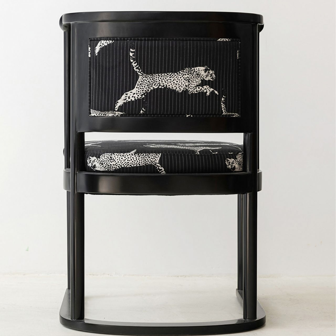 Elegant black fabric dining chair with leopard pattern