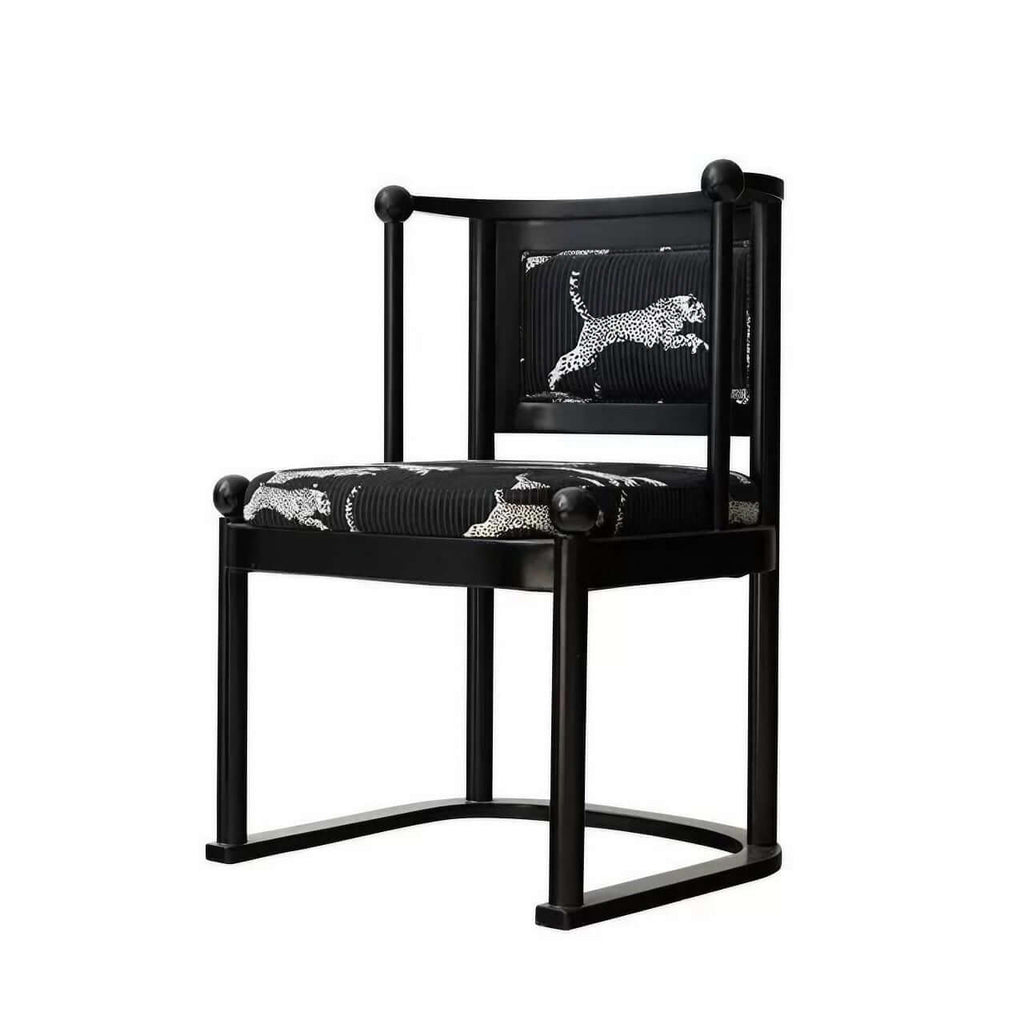 Single vintage dining chair with black fabric and leopard print upholstery