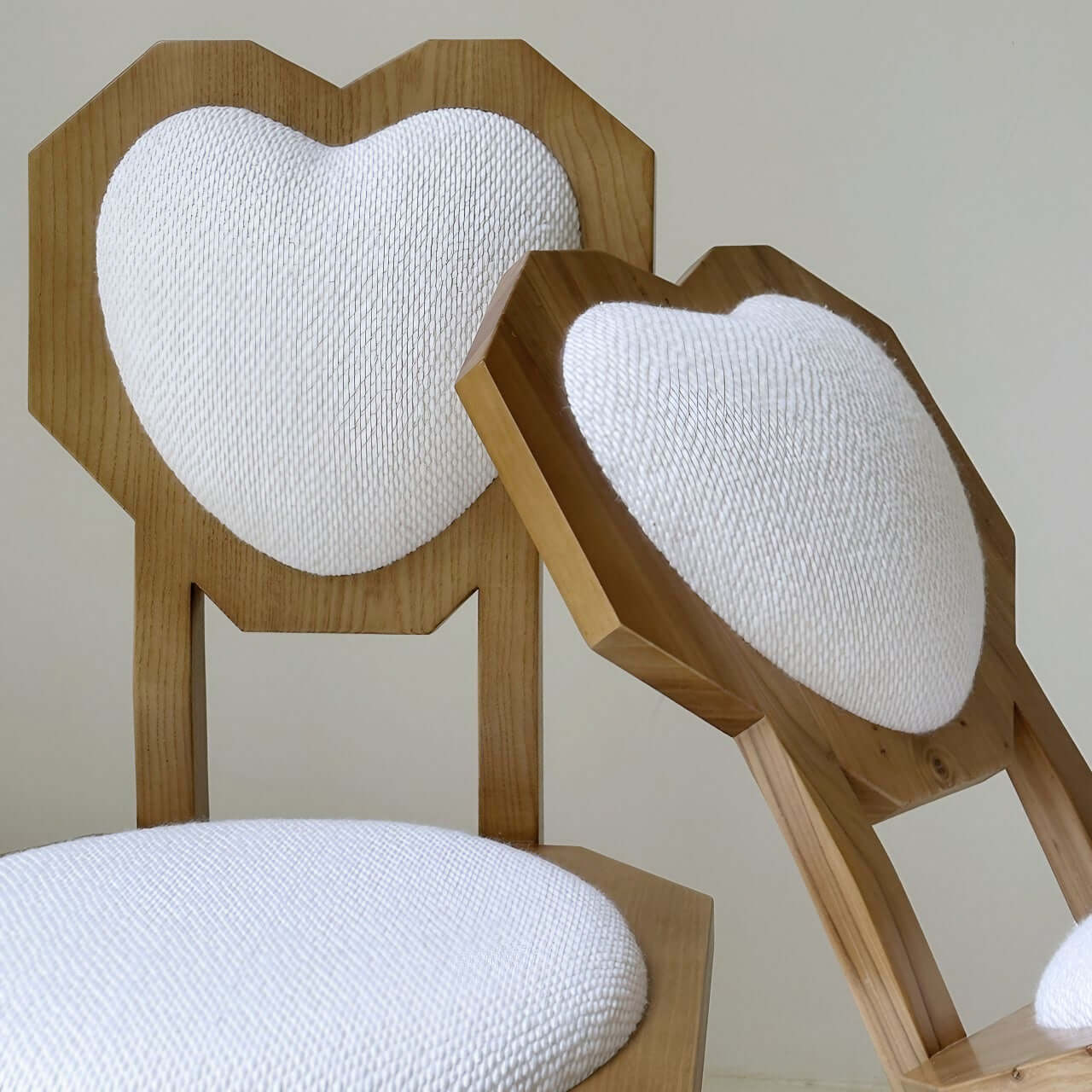 Single white woolen dining chair with heart-shaped back and high aesthetic design