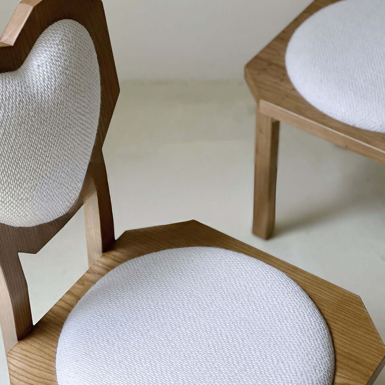 Single white woolen dining chair with heart-shaped back and high aesthetic design