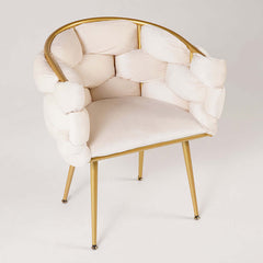 Stylish beige velvet armchair with gold-finished legs for luxurious home decor