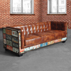 Three-seater brown faux leather sofa with a vintage industrial loft style