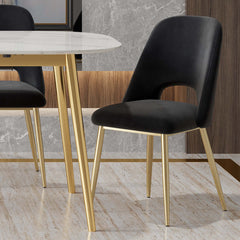 Elegant contemporary black dining chair with hollow back and gold metal legs