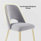 Sleek modern upholstered dining chairs in black with hollow back and shiny gold legs