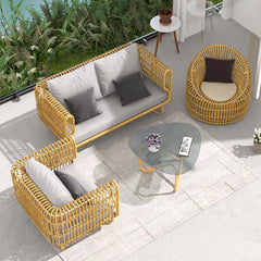 Yellow cushioned outdoor rattan sofa set with glass table