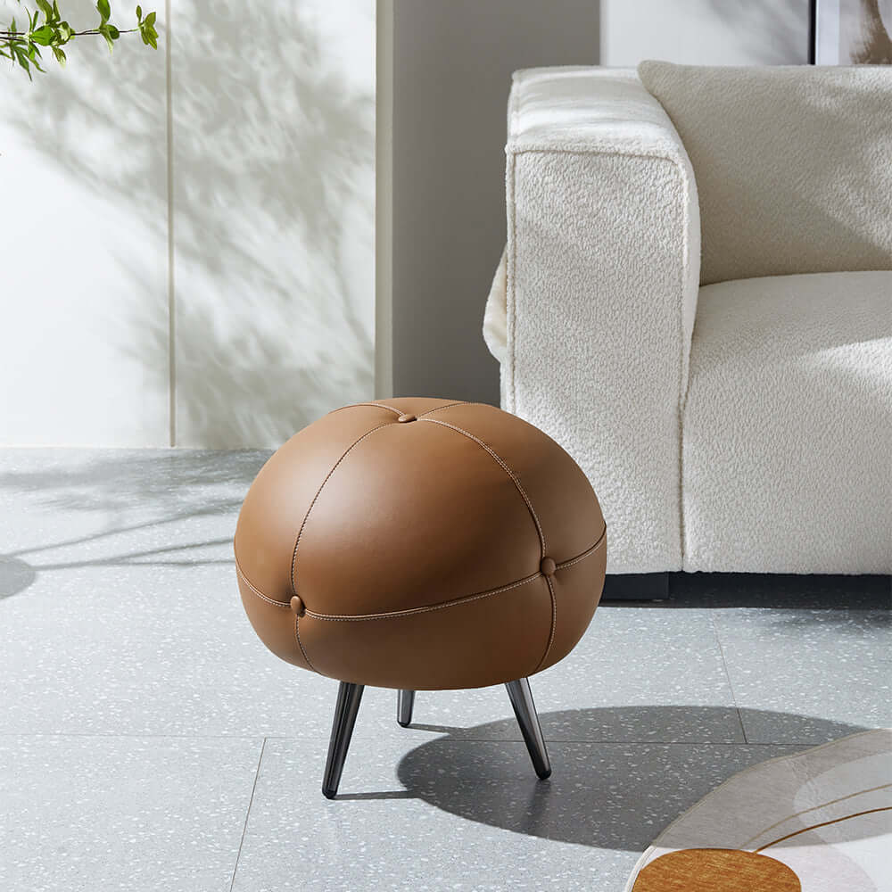 Modern round brown ottoman with buttoned faux leather upholstery for contemporary home decor Imagen principal del producto