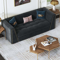 Modern deep gray velvet sofa with tufted upholstery