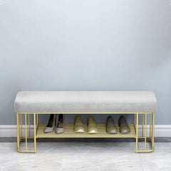 Modern green velvet upholstered storage bench with golden frame and shelves