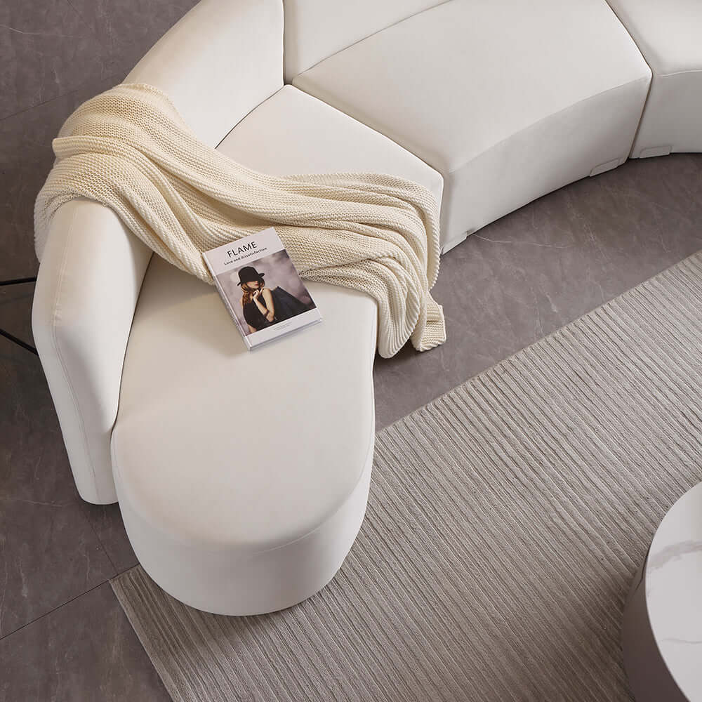 Stylish white curved sectional floor sofa with luxurious velvet upholstery