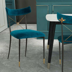 Blue upholstered dining chair with cross back design and green side chair