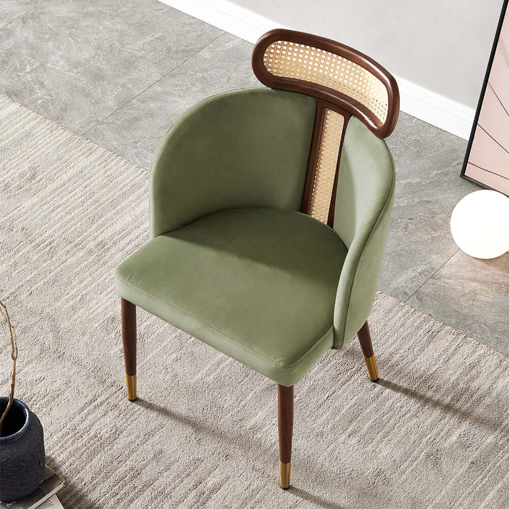 Modern green velvet dining chair with curved back design for comfortable seating