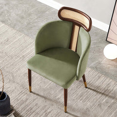 Modern green velvet dining chair with curved back design for comfortable seating