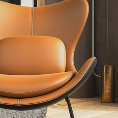 Chic modern chair in orange and black with cushioned PU leather upholstery and pillow