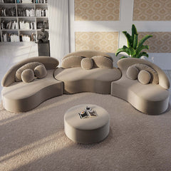 Beige velvet upholstered 7-seat sofa with round sectional design, ottoman, and cozy throw pillows for relaxation