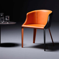 Modern black and orange leather dining chair with metal legs for stylish dining room decor