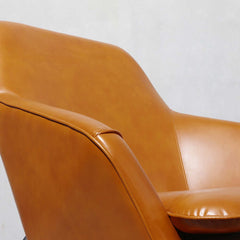 Modern caramel PU leather accent chair with sleek black carbon steel finish and armrests