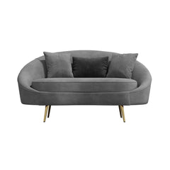 Modern 63 inch pink velvet sofa with curved design, gold metal frame, and matching toss pillow