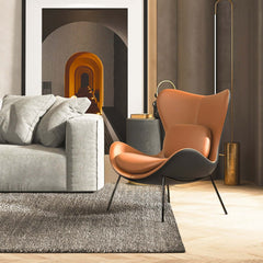 Stylish orange and black accent chair with sleek PU leather upholstery and matching pillow