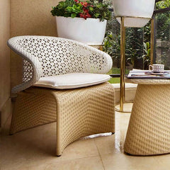 Hofer patio arm chair with white cushion, weather-resistant rattan, arched bottom, and low-back design