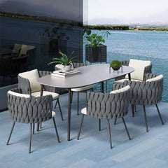 7 piece outdoor dining set featuring faux marble top and rope woven chairs