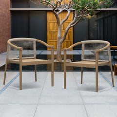 Two sleek teak wood outdoor armchairs in natural and beige