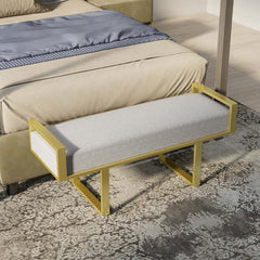 Elegant gray upholstered bench with gold legs, perfect for modern bedroom and entryway