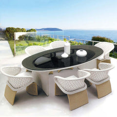 Modern aluminum outdoor dining set with oval glass table and rattan armchair