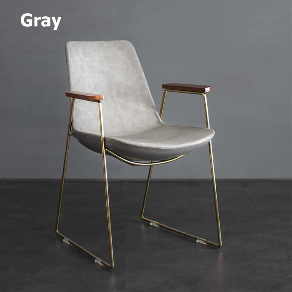 Elegant black dining chair with gold legs and faux leather upholstery for modern dining room