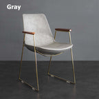 Elegant black dining chair with gold legs and faux leather upholstery for modern dining room