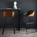 Black metal bar stool with faux leather upholstery for comfortable seating