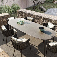 Faux marble top aluminum table with 7 pieces of rope woven chairs for outdoor dining