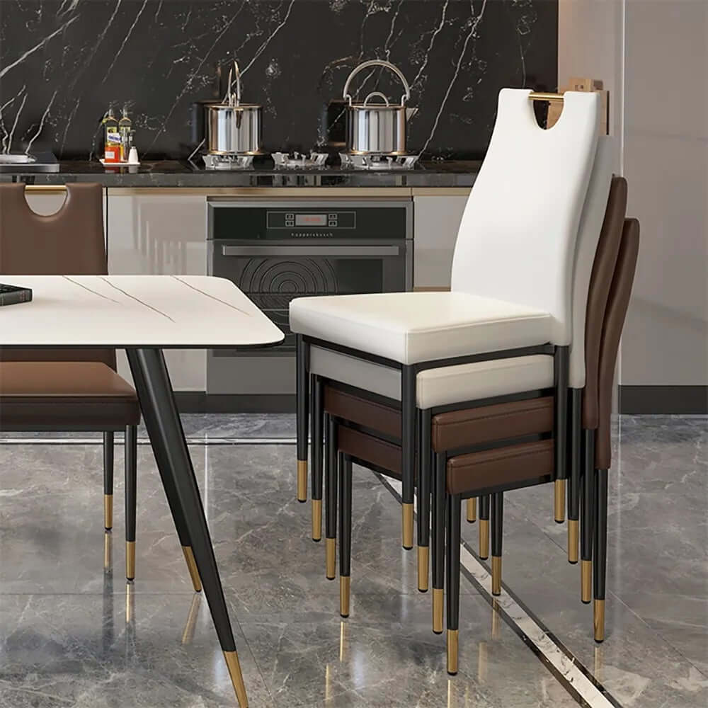 Two modern black dining chairs featuring plush upholstery and steel legs