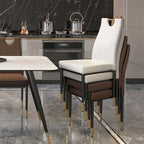 Two modern black dining chairs featuring plush upholstery and steel legs