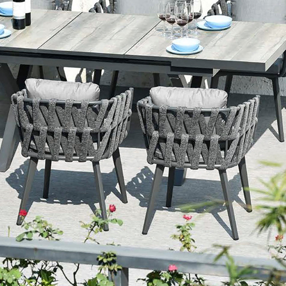 Outdoor dining set with extendable ceramic table and woven aluminum armchairs, 7 pieces