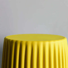 Stylish plastic side table in yellow for modern interior decor