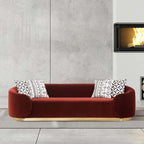 Pink sofa with plush velvet upholstery and cushions