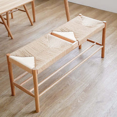 Chic natural rattan bench with strong wood legs for a stylish dining room seating option