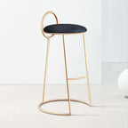 Trendy gray velvet bar stool with low back and glamorous gold legs for stylish home furnishings