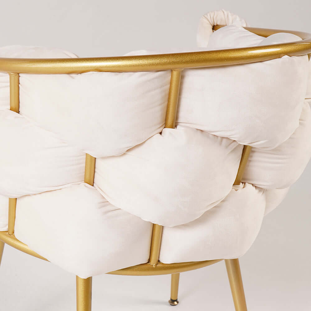Sophisticated beige upholstered armchair with shimmering gold legs for luxury interiors