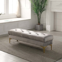 Light gray velvet upholstered bench with tufted design and sturdy metal legs