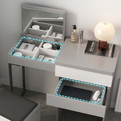 Modern gray makeup vanity with foldable mirror and stool, creating a functional and sophisticated beauty station