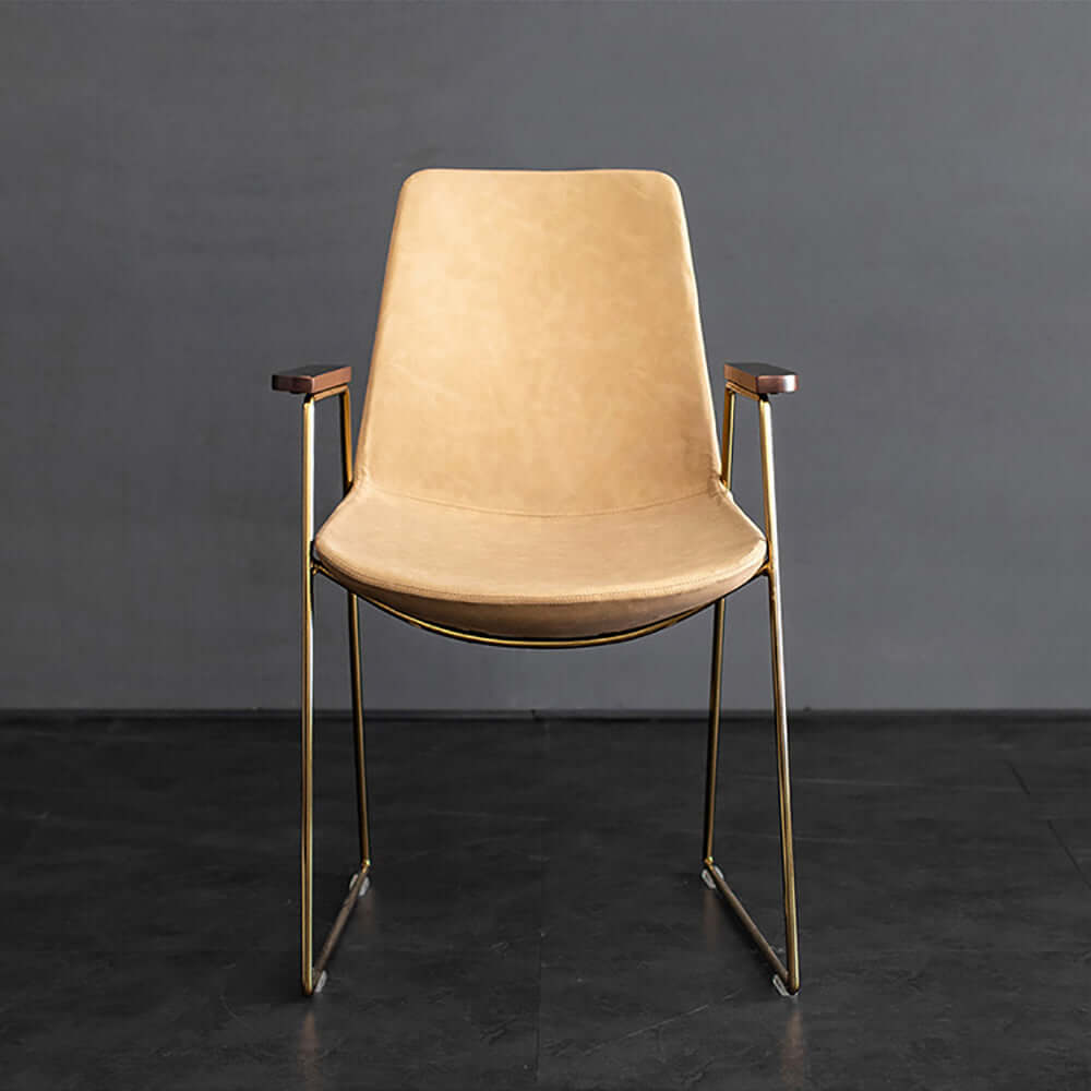 Sophisticated upholstered dining chair with gold legs in black faux leather material