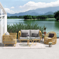 Rattan outdoor furniture set with yellow cushions and glass top table