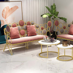 Luxurious pink velvet loveseat with elegant gold metal frame