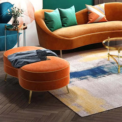 Stylish upholstered bench with luxurious orange velvet and gold legs