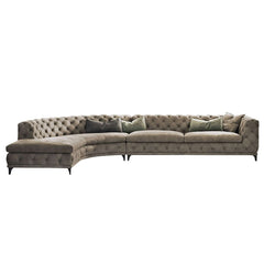 Curved gray velvet upholstered LShaped chesterfield sofa for stylish living rooms