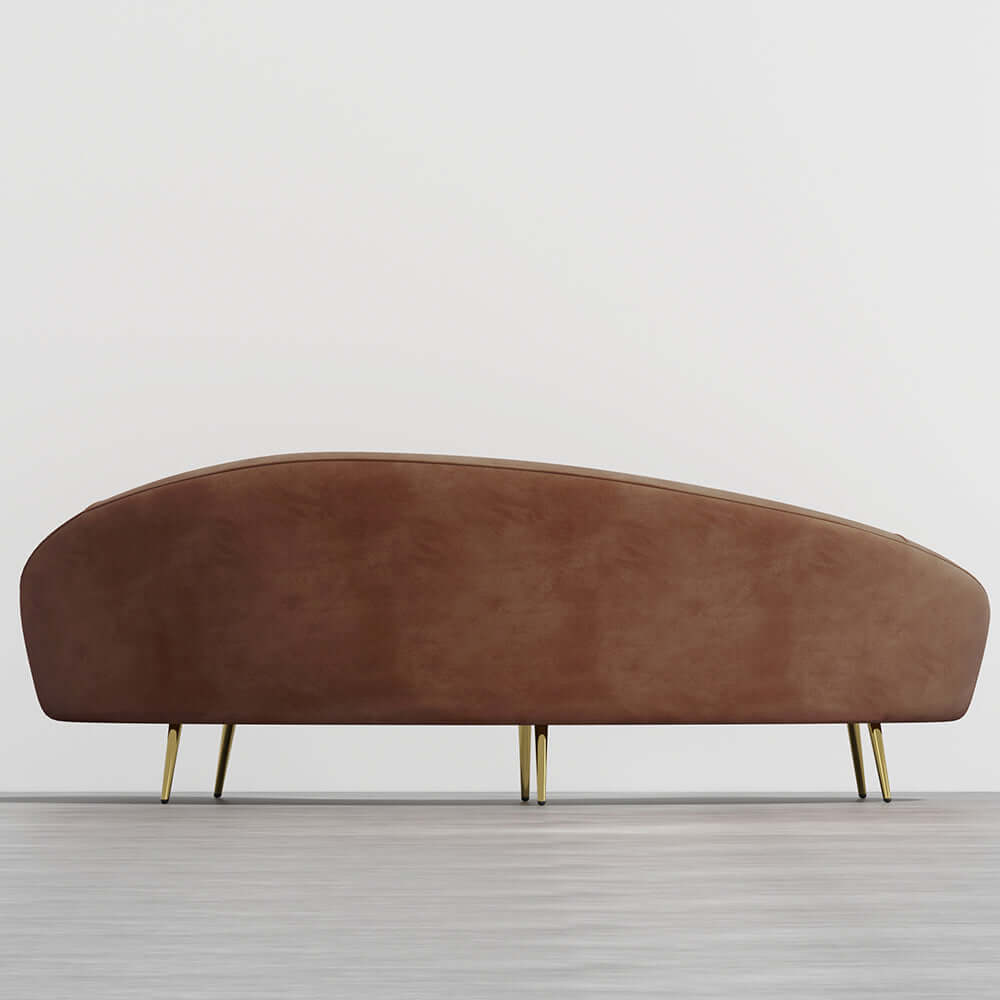 Modern 63 inch pink velvet sofa with curved design, gold metal frame, and matching toss pillow