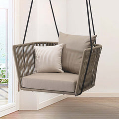 Modern outdoor hanging chair with brown rattan design and khaki cushion pillow